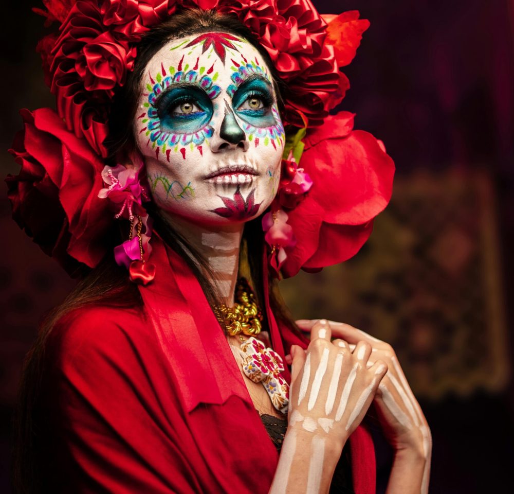 Colorful Catrina face paint and floral attire symbolizing Day of the Dead in Mexico City.